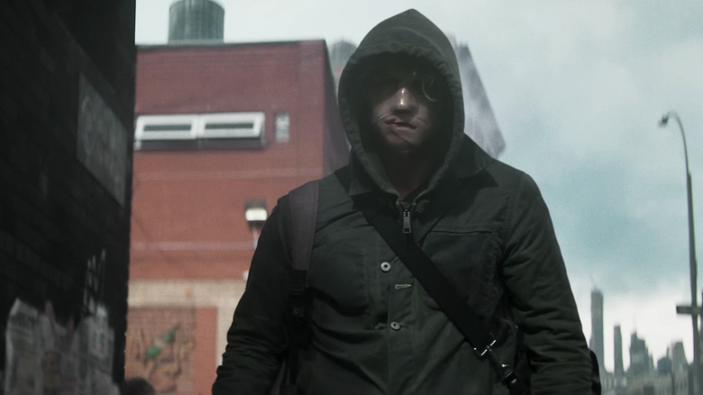 Tom Rhys Harries' Matt Hagen walks through Gotham City with his hood up in Clayface