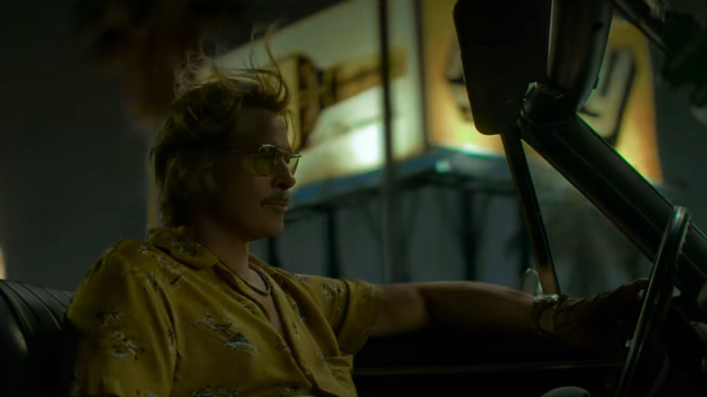 Cliff Booth driving in a convertable in The Further Mid-Adventures of Cliff Booth