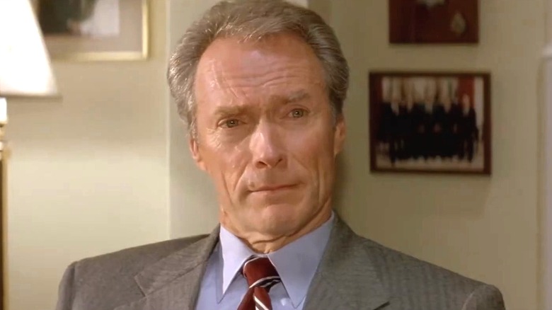 Frank Horrigan sitting and looking at someone off-screen during In the Line of Fire