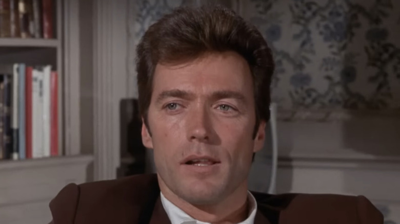 Clint Eastwood's Walter Coogan smiles and looks off to his right as he sits down in Coogans' Bluff
