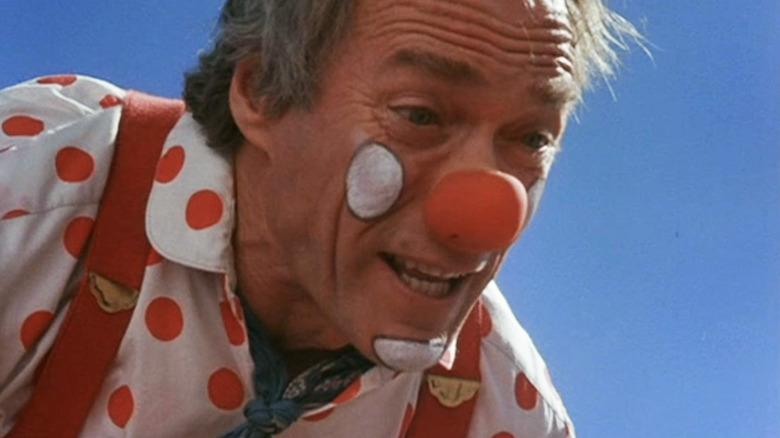 Clint Eastwood, when Tommy Nowak is seen dressed in Pelle outfit and makeup against the blue sky in Pink Cadillac