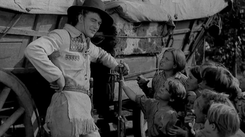 John Wayne's Breck Coleman talks to a group of kids in The Big Trail
