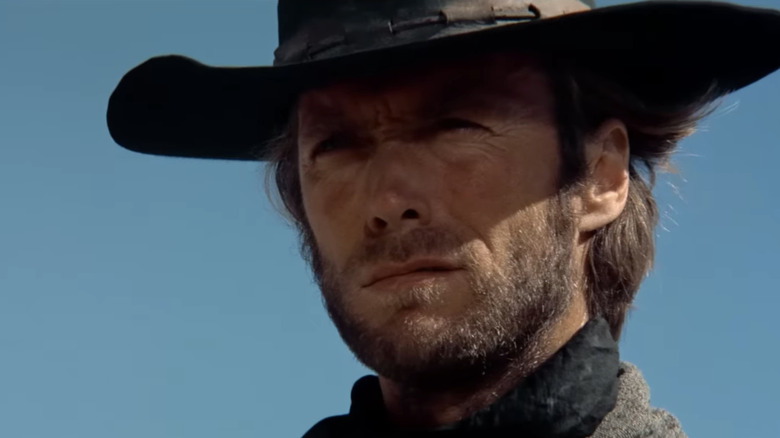 Clint Eastwood's The Stranger is seen in closeup against a blue sky in High Plains Drifter