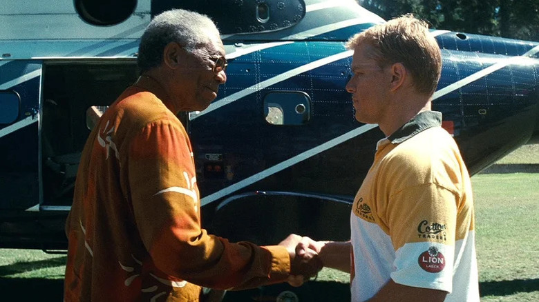 Morgan Freeman's Nelson Mandela shakes the hand of Matt Damon's Francois Pienaar as they stand in front of a helicopter in Invictus