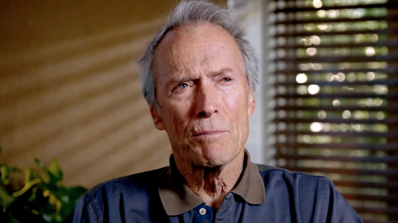 Clint Eastwood sitting down in a featurette for American Sniper