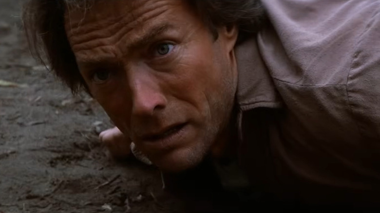 Josey Wales (Clint Eastwood) laying on the ground in The Outlaw Josey Wales