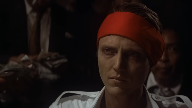 Christopher Walken's Nikanor Chevotarevichin sits in a red bandana in The Deer Hunter