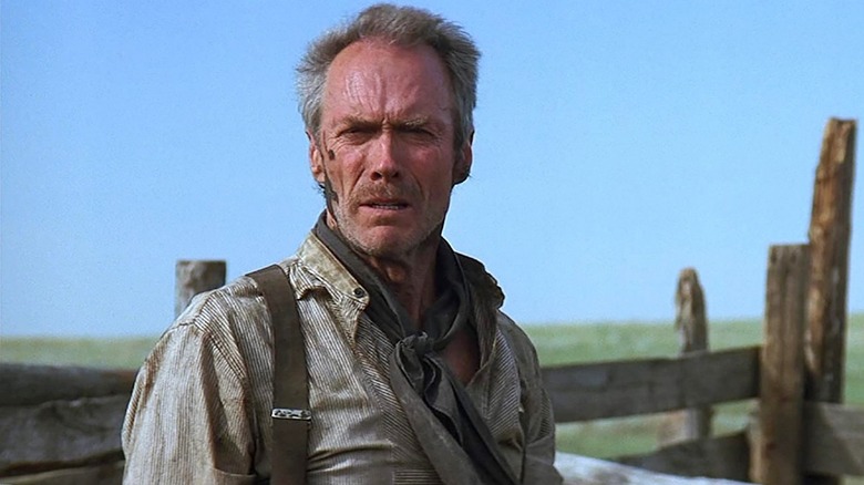 Clint Eastwood has a splotch of pig mess on his face as Will Munny in Unforgiven