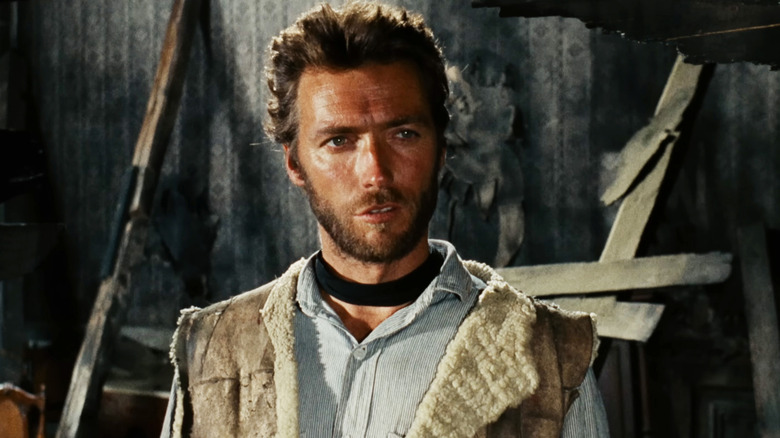 Clint Eastwood's Man with No Name stands in a dilapidated house in The Good, the Bad, and the Ugly