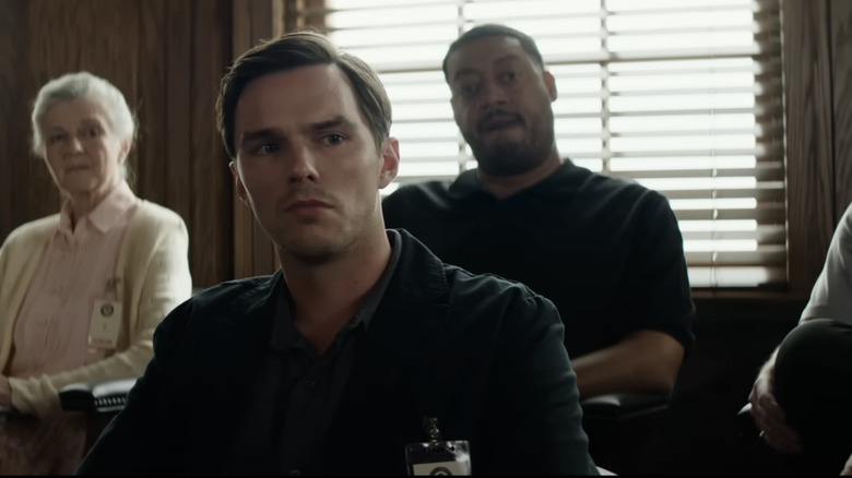 Justin Kemp de Nicholas Hoult se sienta entre sus compañeros del jurado en la sala del jurado en el jurado n.° 2