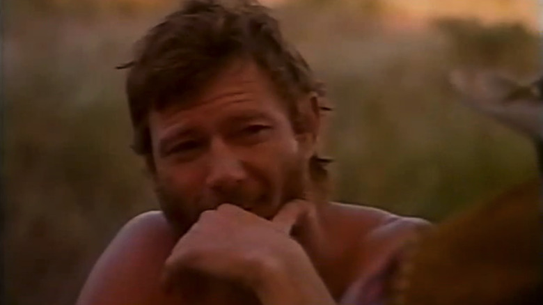Michael Parks' Josey Wales holds his hand up to his face in closeup in The Return of Josey Wales