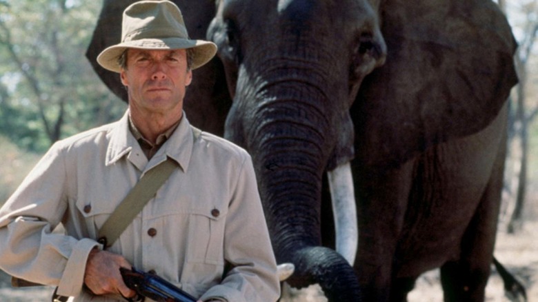 Clint Eastwood posing in front of an elephant