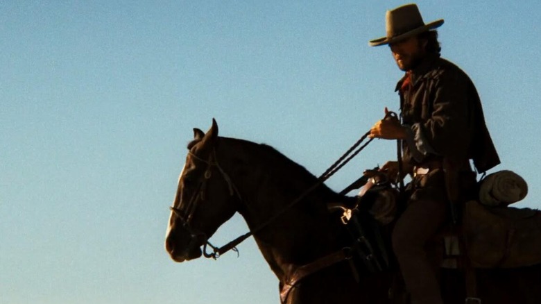Clint Eastwood in silhouette, on horseback