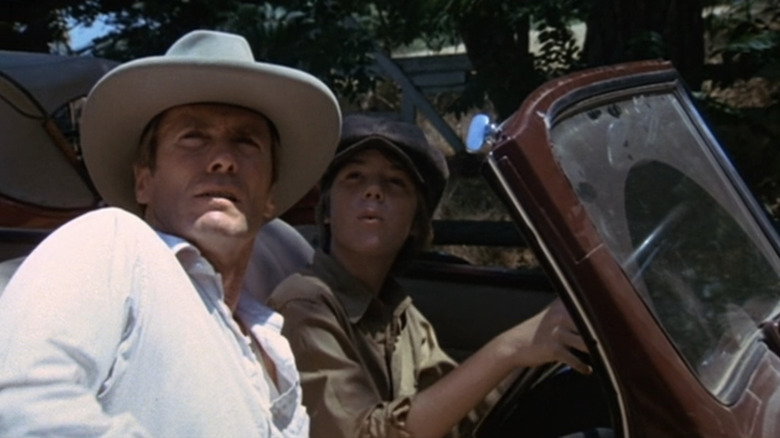 Clint Eastwood's Red Stovall sits in a car alongside Kyle Eastwood's Whit Wagoneer in Honkeytonk Man