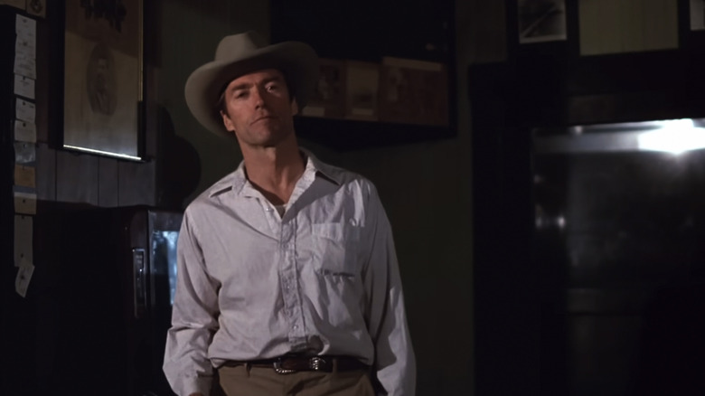 Clint Eastwood's Red Stovall wears a cowboy hat and looks at someone off camera in Honkeytonk Man