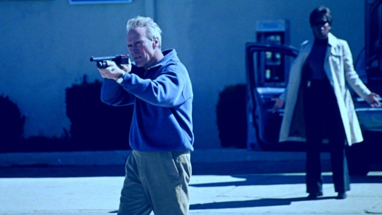 Clint Eastwood as Terry McCaleb blasts away with a shotgun while Tina Lifford looks on as Jaye Winston in Blood Work