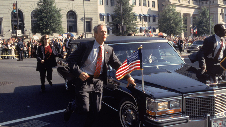 Clint Eastwood running alongside the presidential limo