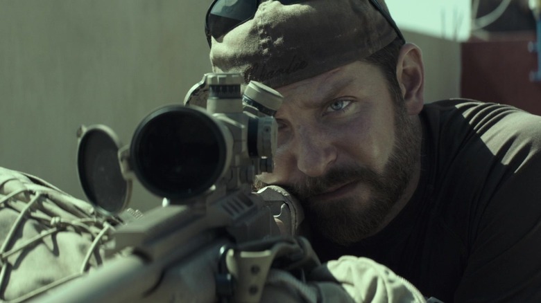 Bradley Cooper's Chris Kyle aims his sniper rifle in American Sniper