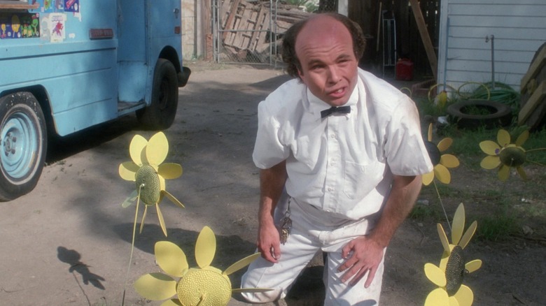 Gregory Tudor among plastic sunflowers in Ice Cream Man