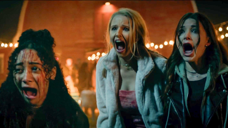 Ronnie, Janet, and Quinn screaming outside of the barn in Clown in a Cornfield