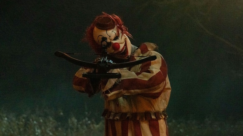 Frendo the Clown holding a crossbow in Clown in a Cornfield