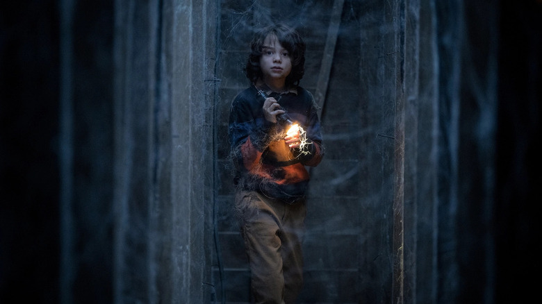 Woody Norman in Cobweb with flashlight