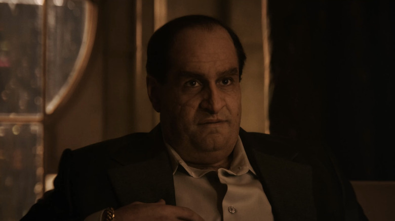 Colin Farrell's Penguin looks up as he sits down in The Penguin