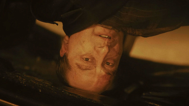 Colin Farrell's Oswald Cobb looks out from his upturned car in The Batman