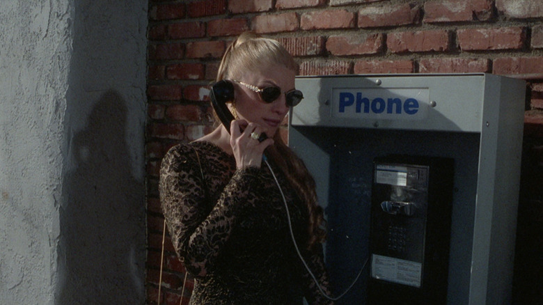 Trish Fairbanks holding a phone in "Columbo and the Death of a Rock Star"