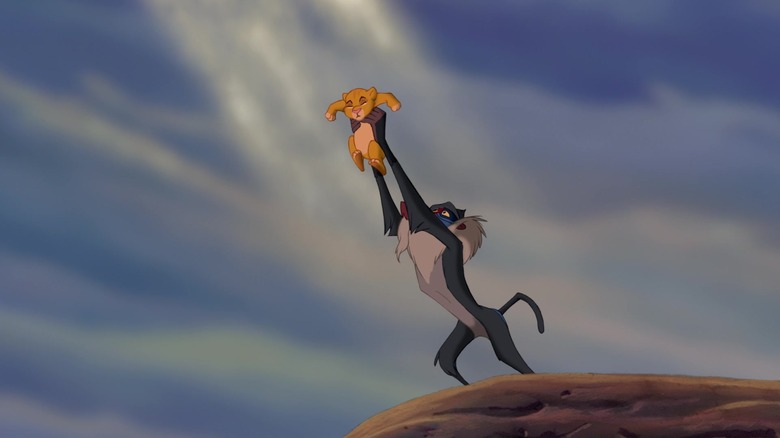 Rafiki holding up baby Simba in The Lion King
