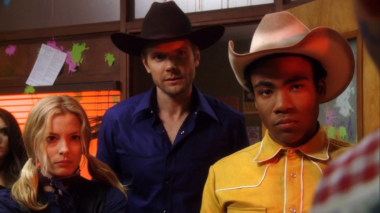 Britta, Jeff, and Troy glaring with cowboy hats on in Community