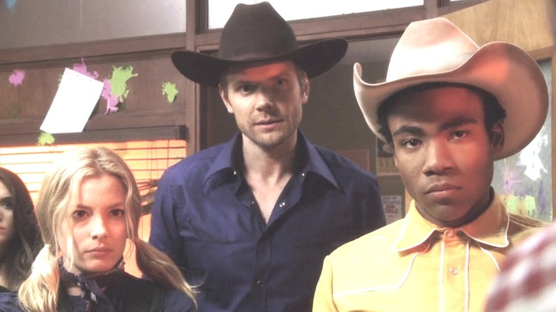 Britta, Jeff, and Troy glaring with cowboy hats on in Community