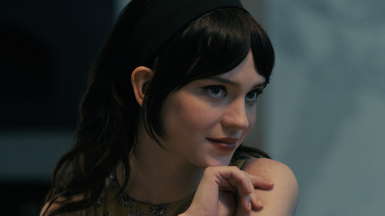 Iris resting her head on her chin in Companion