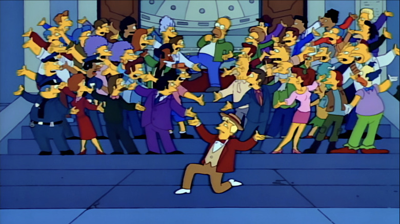 Phil Hartman's Lyle Lanley leads a chorus featuring several Springfieldians on the steps of town hall in The Simpsons