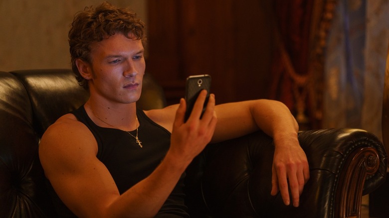 Ilya looking at his phone on Heated Rivalry