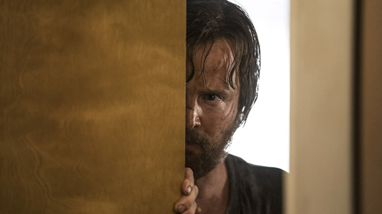 Jesse Pinkman peering around a corner