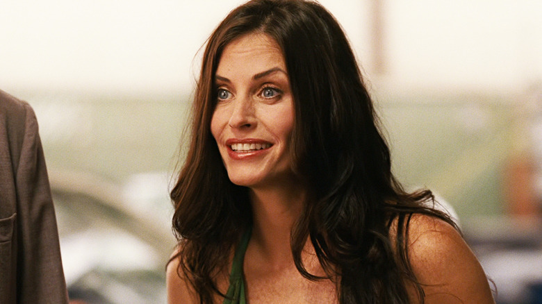 Courteney Cox's Dr Marsha Holloway smiles in closeup in Zoom