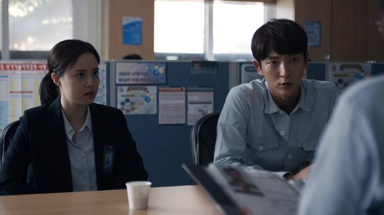 Ha Sun-woo (Moon Chae-won) and Kim Hyun-joon (Lee Joon-gi) sit indignantly at a table in an office in Criminal Minds
