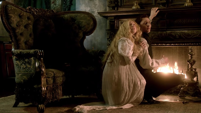 Tom Hiddleston and Mia Wasikowska in front of a fire in Crimson Peak