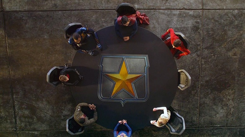 The seven members of The League assembles around a table in Crisis on Infinite Earths: Part Five