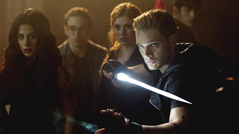 Shadowhunters' Jace draws a glowing blade
