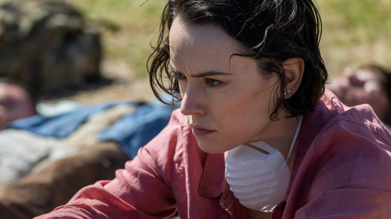 Daisy Ridley as Ava Newman contemplating her new reality while surrounded by zombies in We Bury the Dead