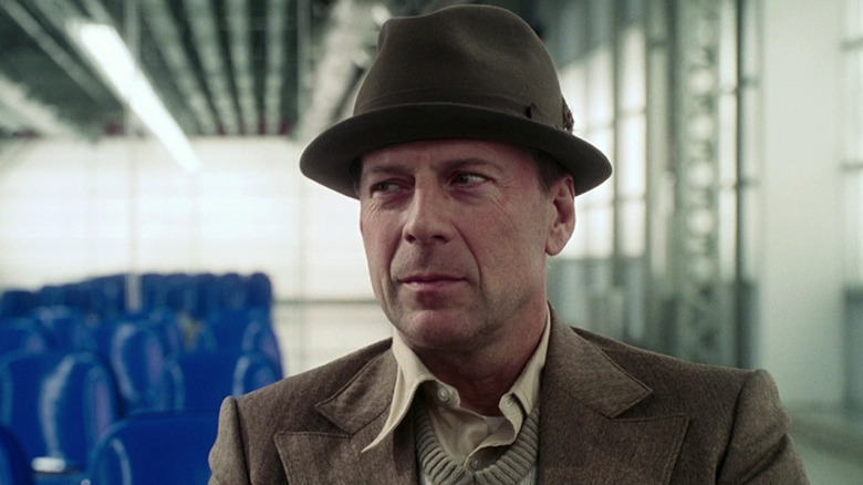 Bruce Willis as Mr. Goodkat sitting at the bus station in Lucky Number Slevin