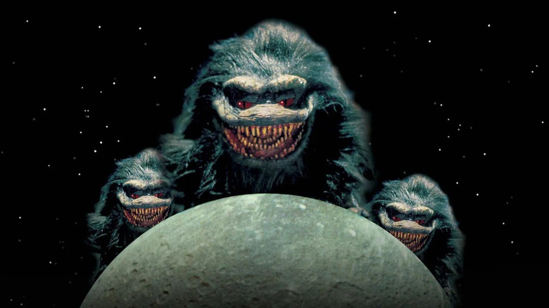 The Krites hovering over the moon on the poster for Critters 4