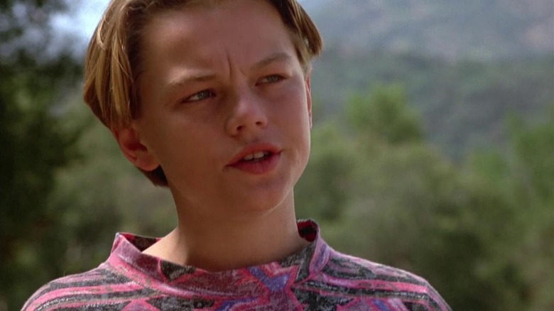 Leonardo DiCaprio as Josh standing in the woods in Critters 3