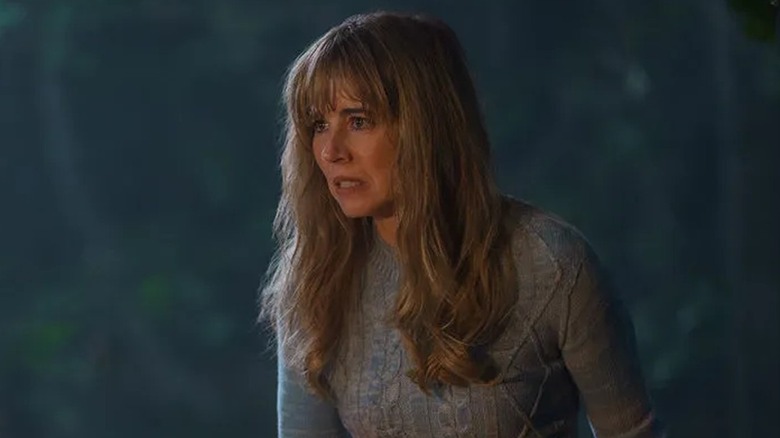 Linda Cardellini as Pamela Voorhees holding a knife in the woods in Crystal Lake