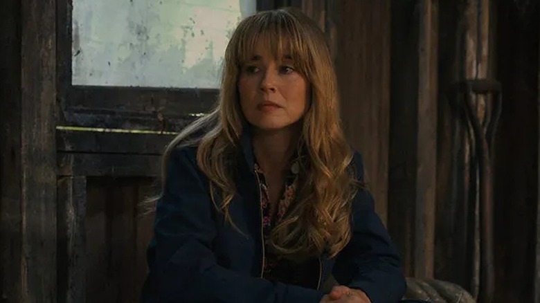 Linda Cardellini as Pam Voorhees sitting in Jason's cabin in Crystal Lake