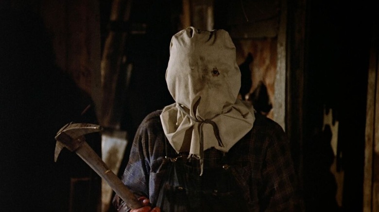 Jason Voorhees holding a pickaxe in Friday the 13th Part 2