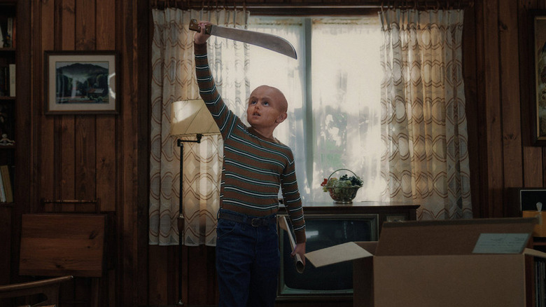 Callum Vinson as the young Jason Voorhees holding his machete in Crystal Lake Season 1