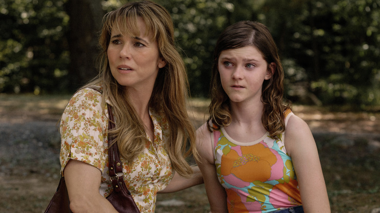 Linda Cardellini as Pam Voorhees holding onto Gwendolyn Sundstrom as Grace in Crystal Lake